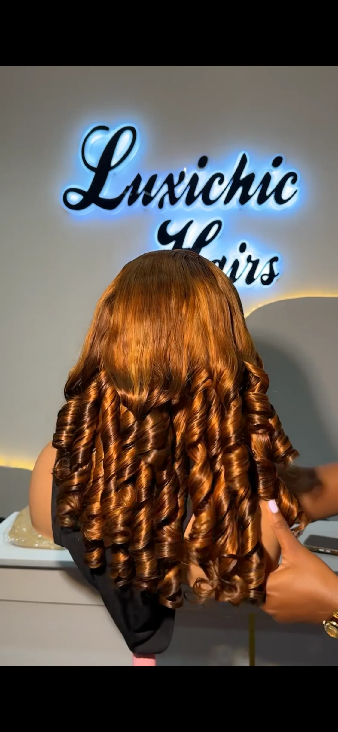 Honey brown curly wig on display at LUXICHIC Hairs